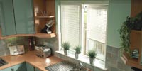 a small size image of wooden venetian blinds in a room from comfort blinds