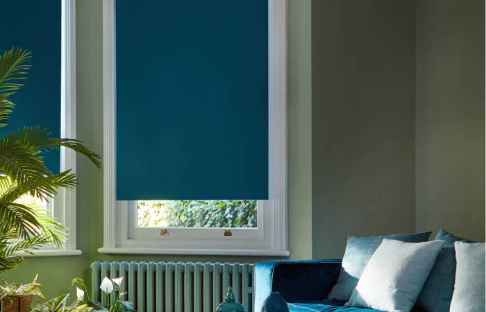 a photo of a blue roller blind in a bedroom from comfort blinds